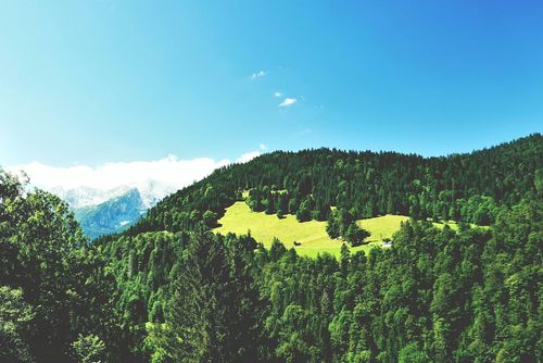 Free Beautiful panoramic view of lush green forests and mountains in Garmisch-Partenkirchen, Bavaria. Stock Photo