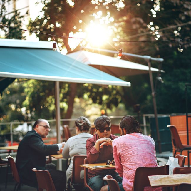small group of people dining outdoors in natural light