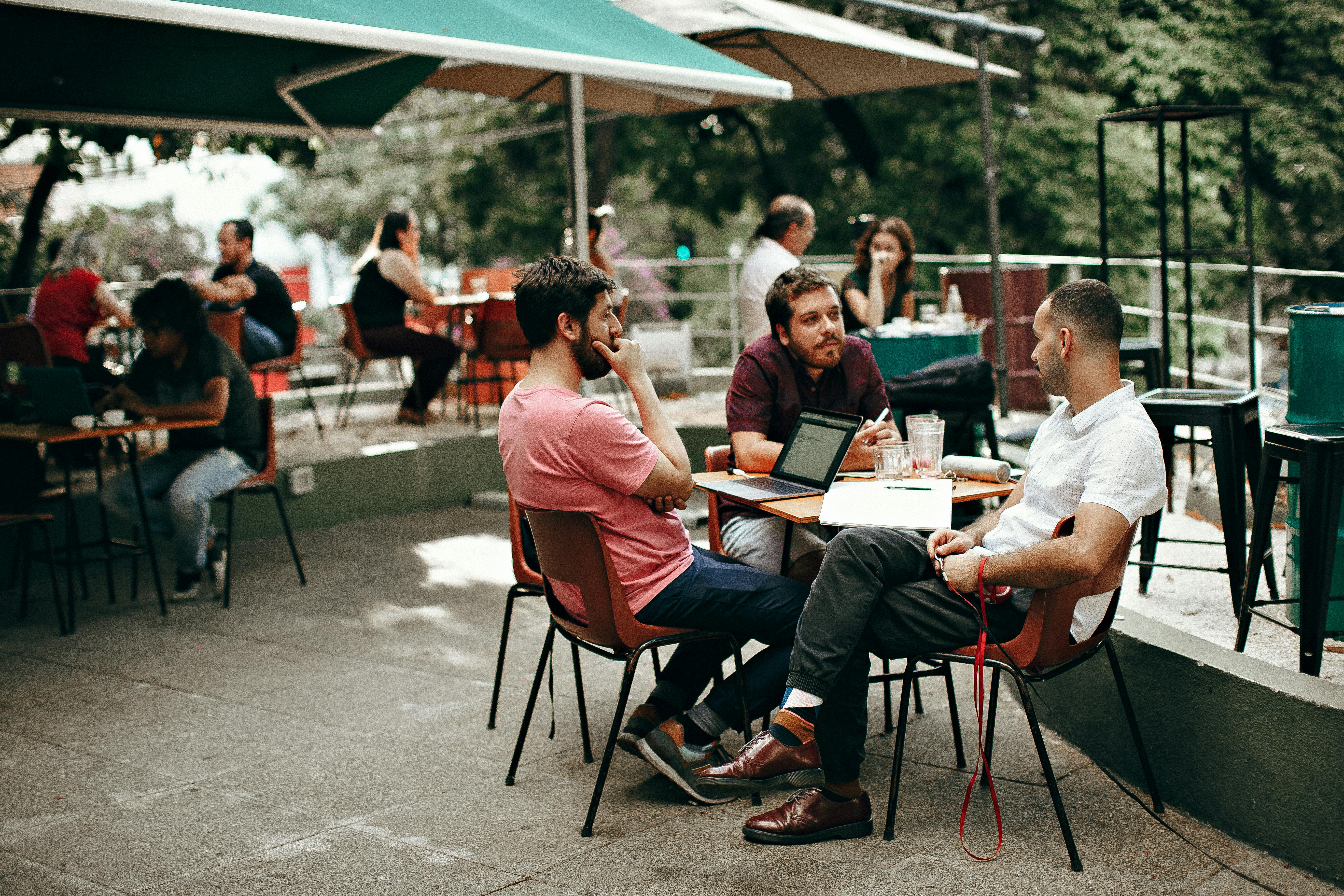 three men sitting at the table