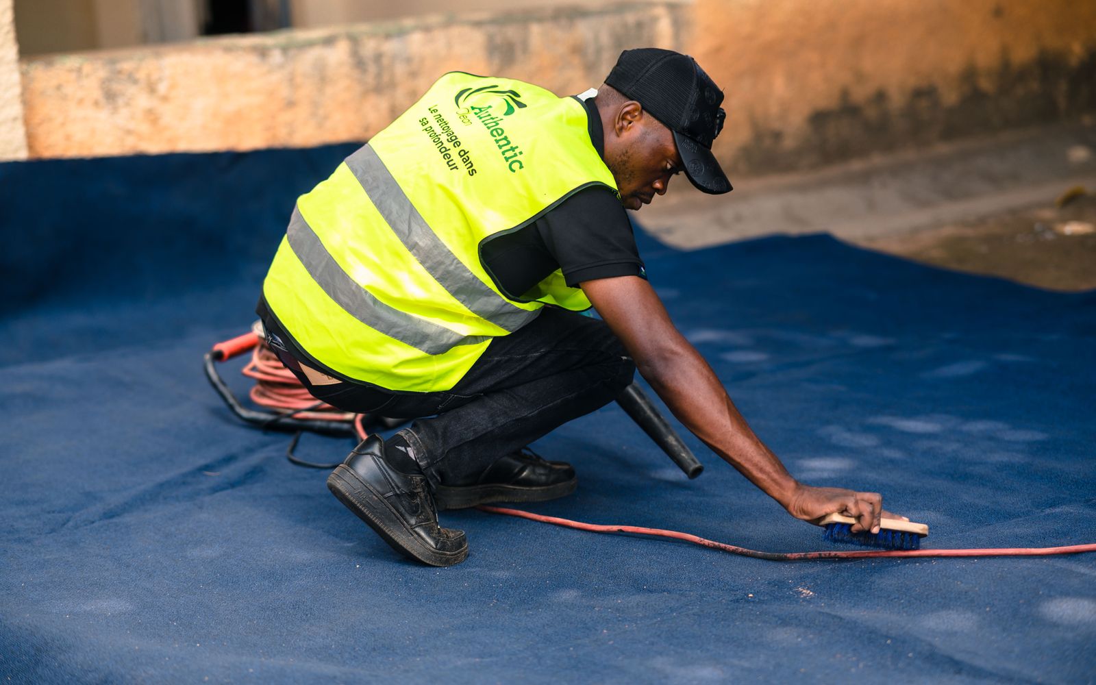 A carpet cleaning operative deep cleaning a carpet