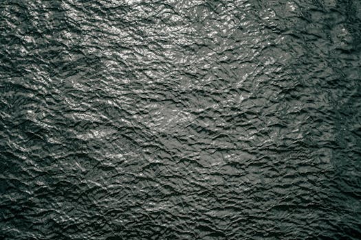 High-resolution image of rippling dark water surface texture, captured outdoors in Berlin, Germany.