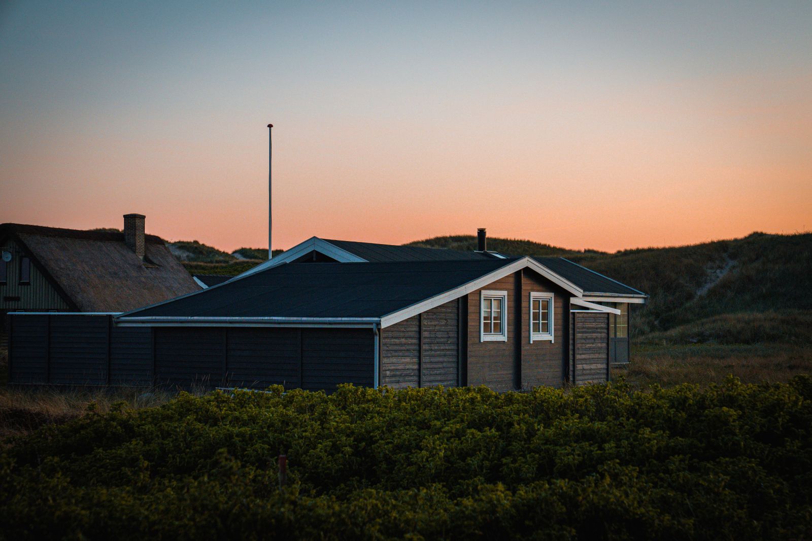 Cosy cottage nestled among the Texel dunes at sunset