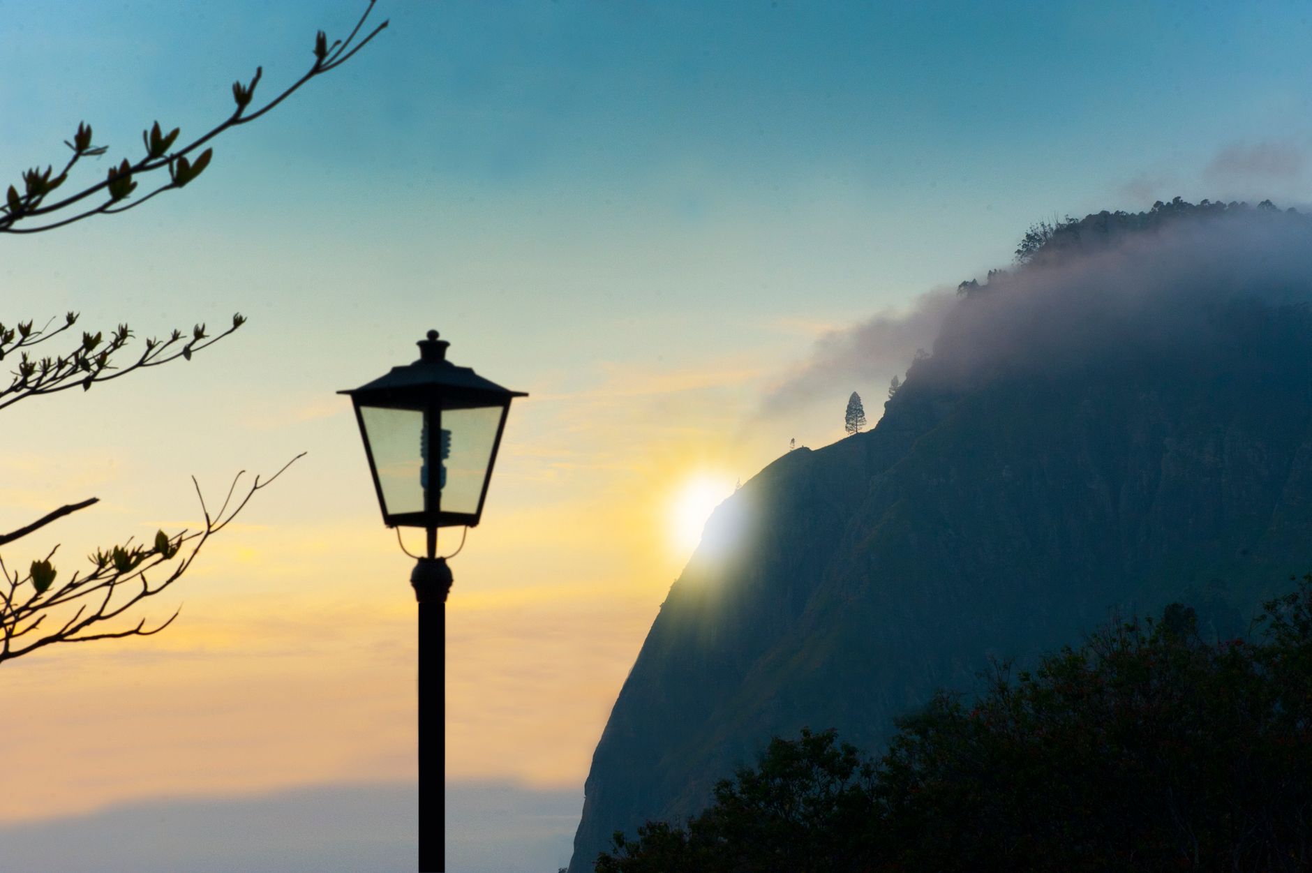 Captivating sunrise with misty mountains and a lamp post in Ella, Sri Lanka.. captivating, sunrise, with