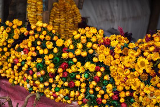 Colorful dried flowers creating a vibrant display at a market stall.