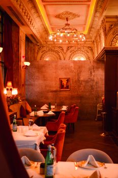 Stylish restaurant in Istanbul featuring ornate ceilings and warm lighting, ideal for fine dining.