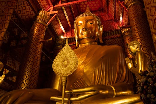 Majestic golden Buddha statue inside Wat Phanan Choeng, Ayutthaya, Thailand.