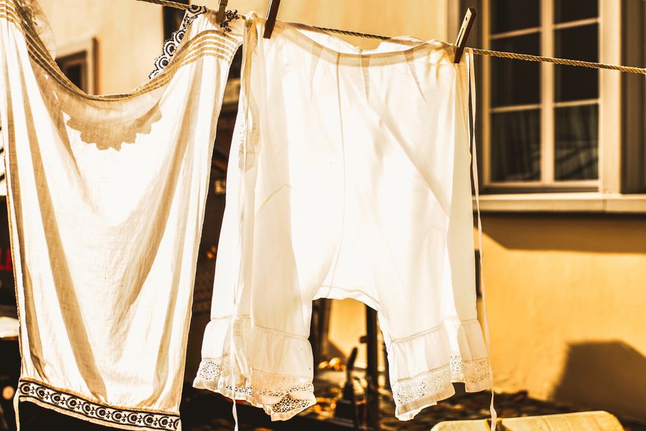 Breathable linen clothing drying in a tropical, sun-soaked setting - capsule wardrobe for summer travel Breathable linen clothing drying in a tropical, sun-soaked setting - capsule wardrobe for summer travel