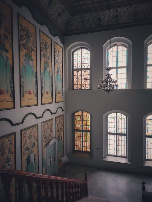 Free A beautifully ornate interior with stained glass windows and classic paintings. Stock Photo