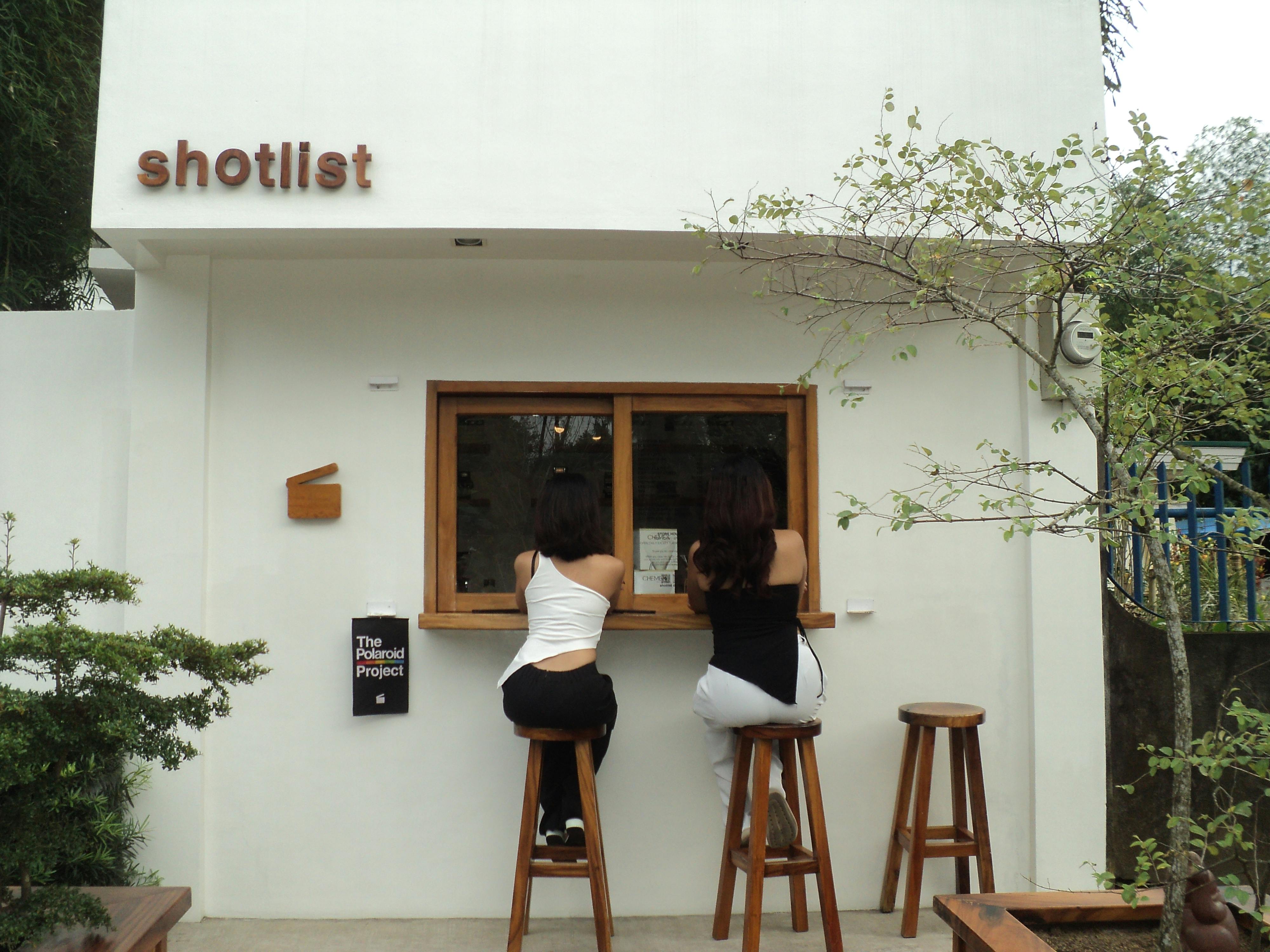 Small plaster-walled espresso bar with single window seat near Dosan Park