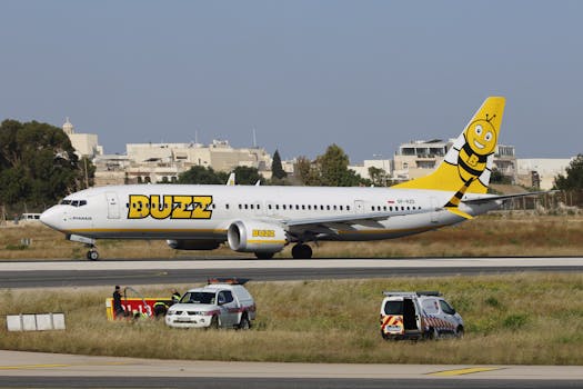Buzz airline plane on runway, featuring bright yellow and bee logo design, ready for takeoff.