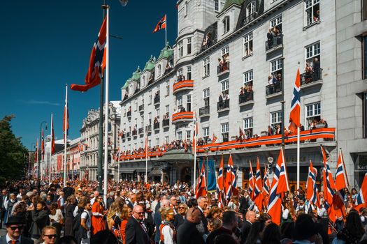 Vibrant street celebration in Oslo during Norwegian Constitution Day.