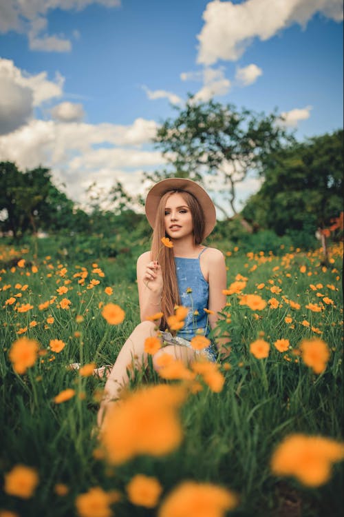 Woman Sitting on Yellow Flower Field