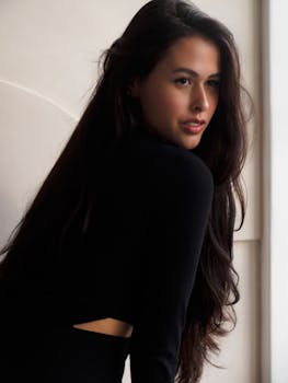 Stylish portrait of a woman in elegant black clothing with natural light.