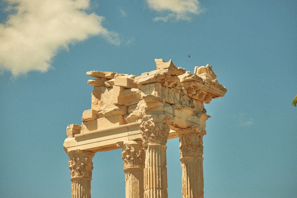 Ancient Roman Temple Ruins Under Blue Sky · Free Stock Photo