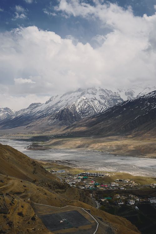 Free A breathtaking view of a village nestled in the Spiti Valley surrounded by mountains. Stock Photo
