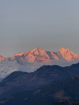Beautiful Himalayan mountains with alpenglow, showcasing serene natural beauty at sunset.