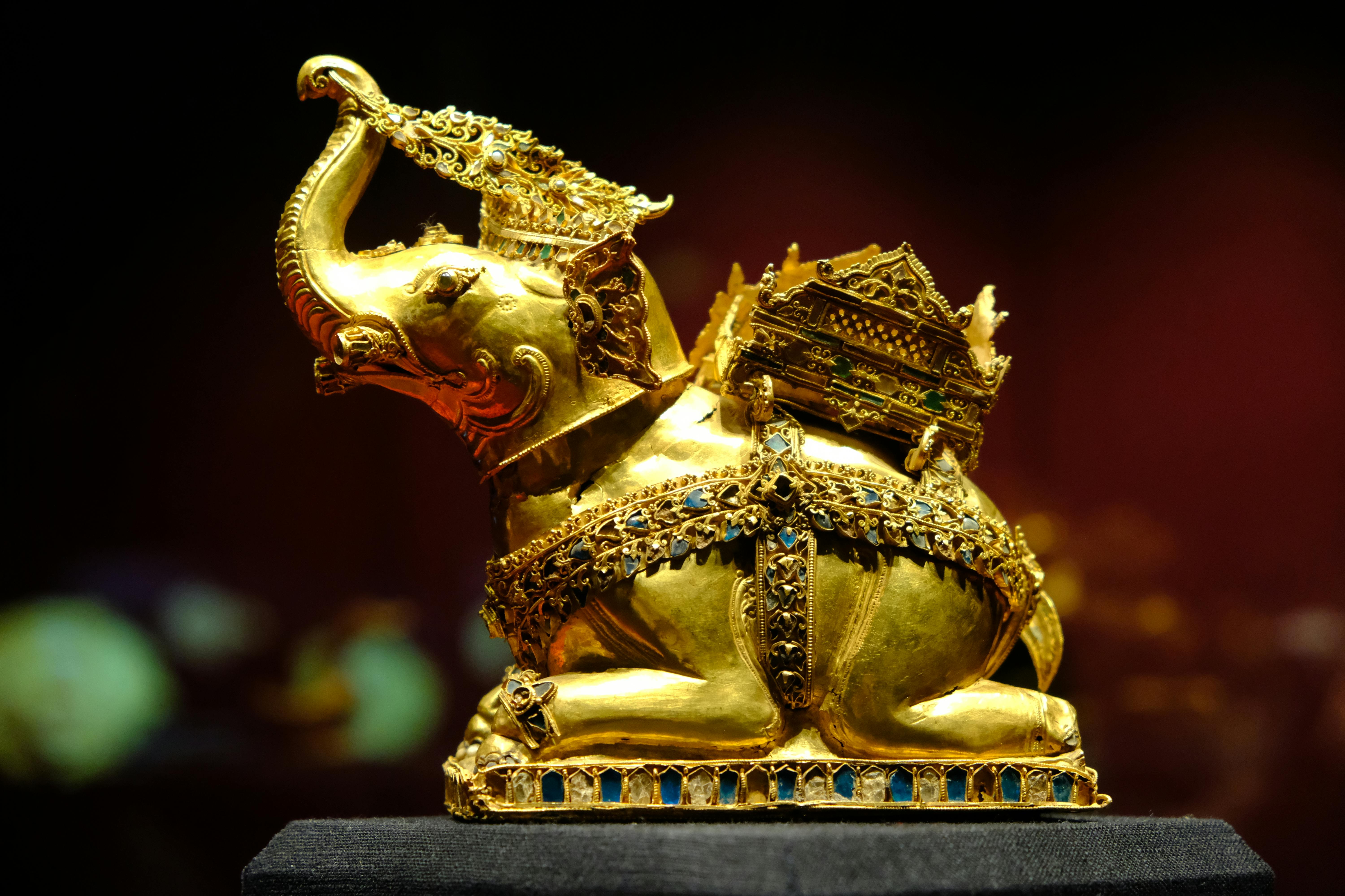 Intricate golden elephant statue with Thai traditional design, photographed in Ayutthaya, Thailand.
