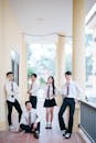 Group of Students in Uniforms Standing in Hallway