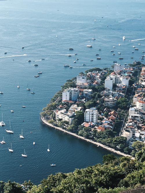 Free Discover the stunning coastline and bustling maritime activity in Rio de Janeiro from above. Stock Photo
