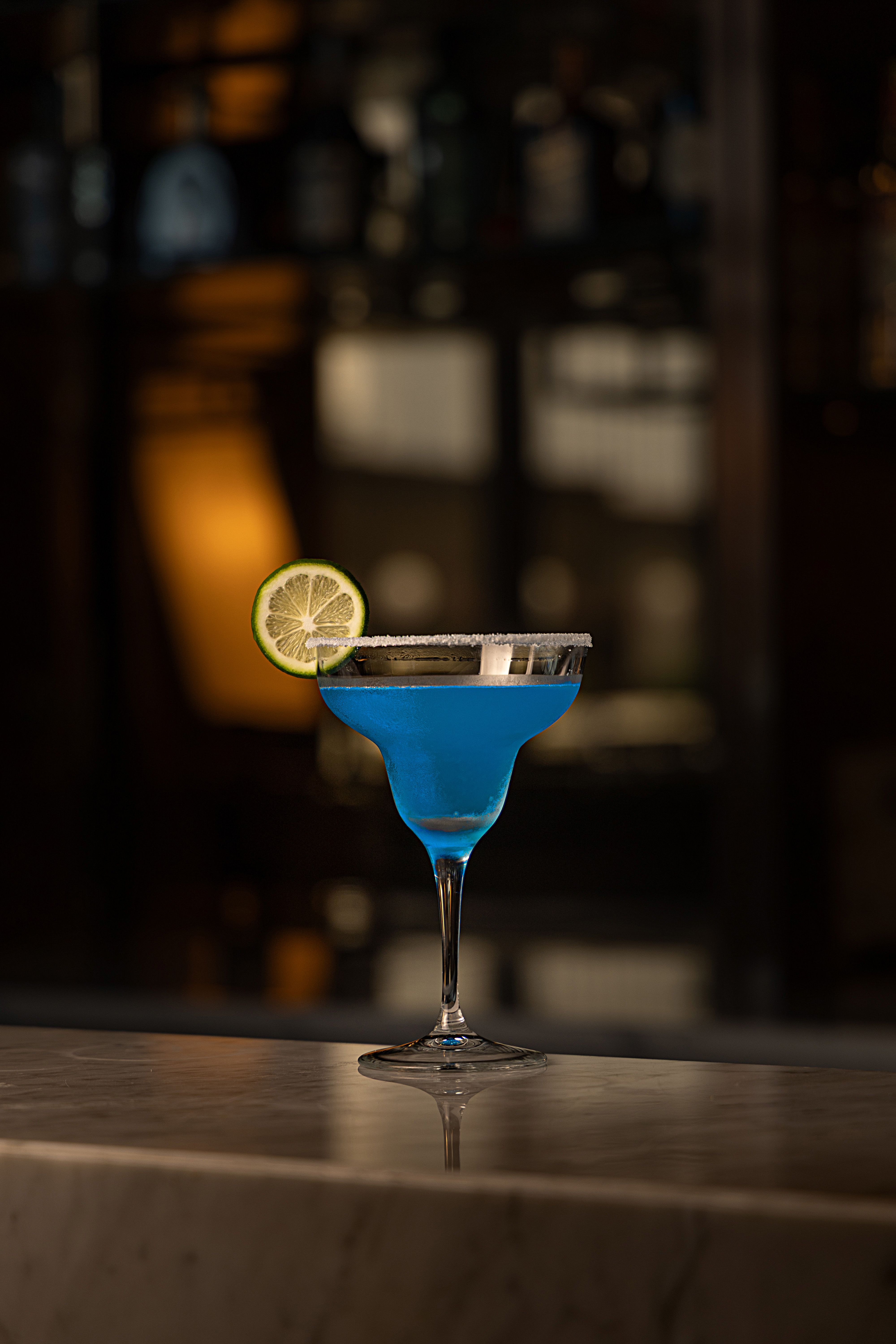 Elegant Blue Cocktail with a Lime Garnish · Free Stock Photo