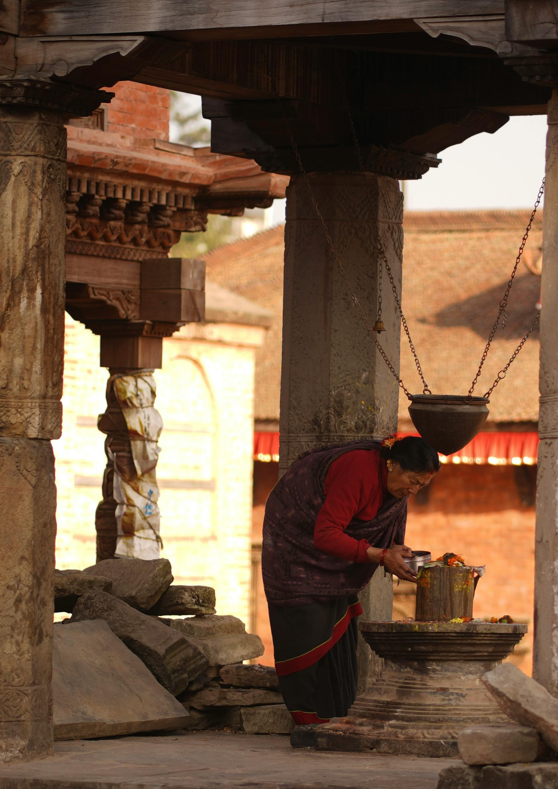 Woman Lighting Candle at Bhaktapur Temple