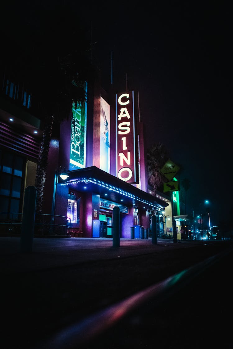 Casino Building With Neon Signboards In Dark Night