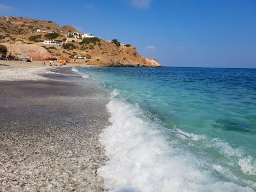 Free Beautiful beach with turquoise waters and rocky coastline in Greece, perfect for relaxation. Stock Photo