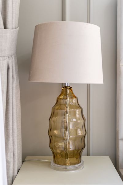 Amber ribbed-glass table lamp with a linen shade. Photo by AJ Ahamad on Pexels