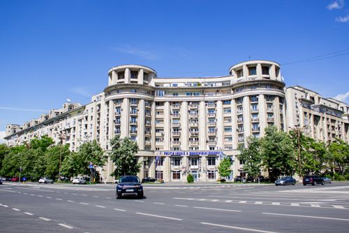 Free Front view of a large apartment building in central Bucharest on a bright day. Stock Photo
