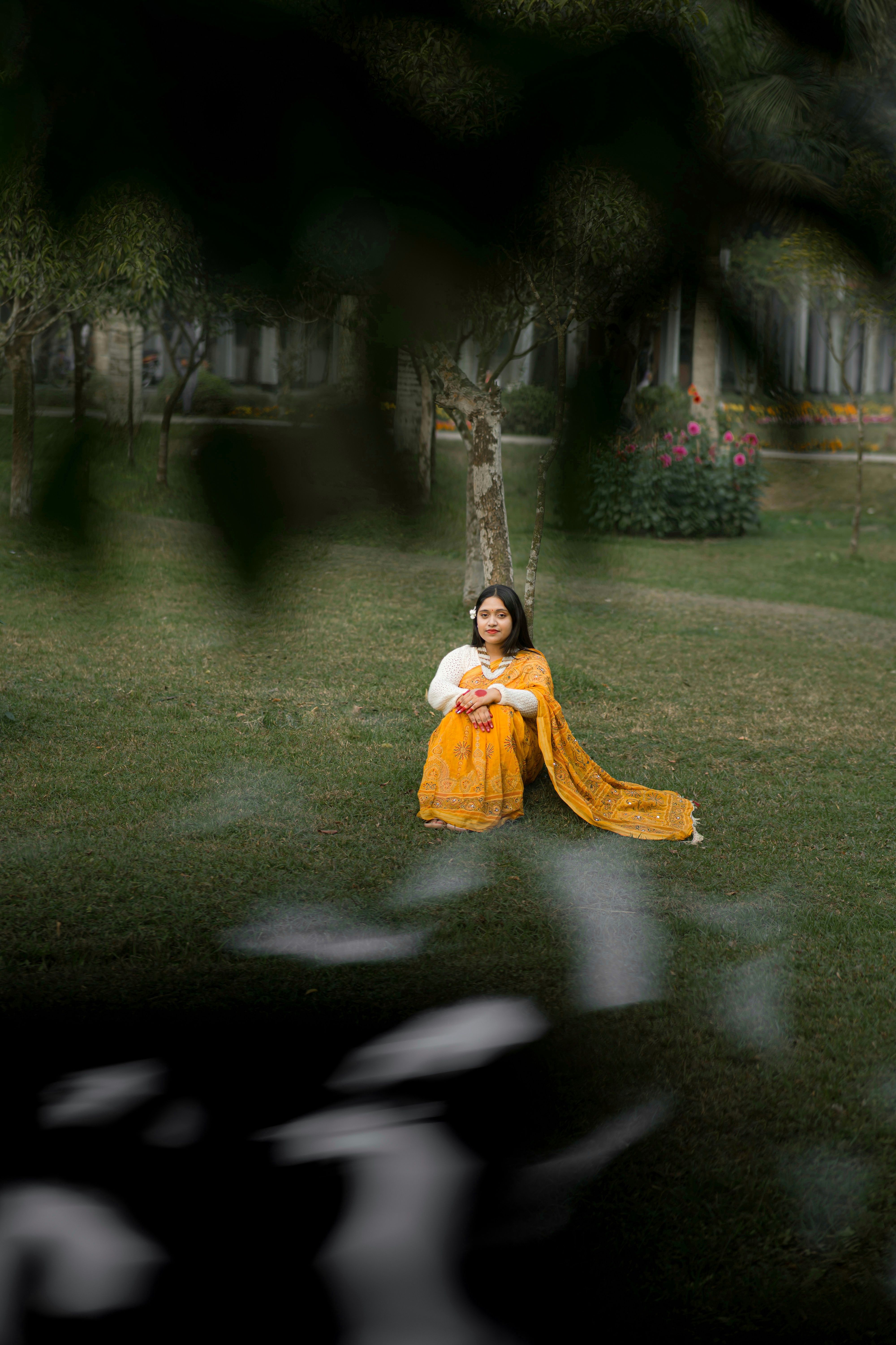 Woman in Yellow Sari Relaxing Under a Tree · Free Stock Photo