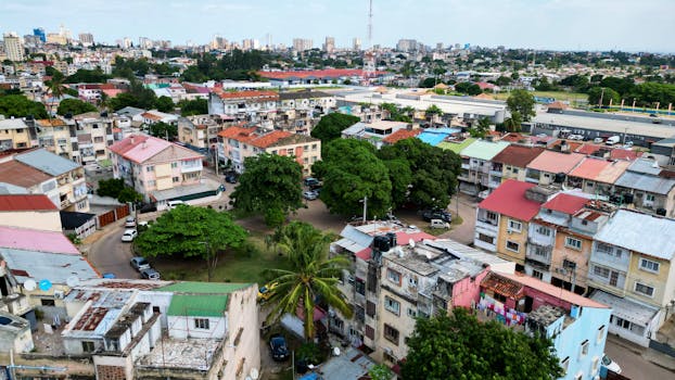 Aerial shot showing colorful residential buildings and greenery in Maputo, Mozambique.