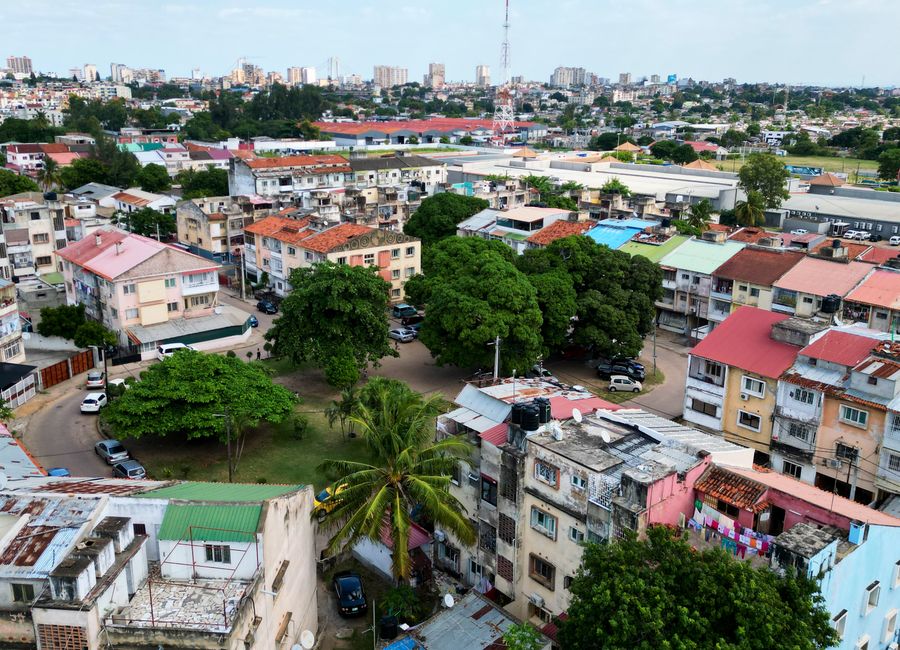 Aerial shot showing colorful residential buildings and greenery in Maputo, Mozambique.