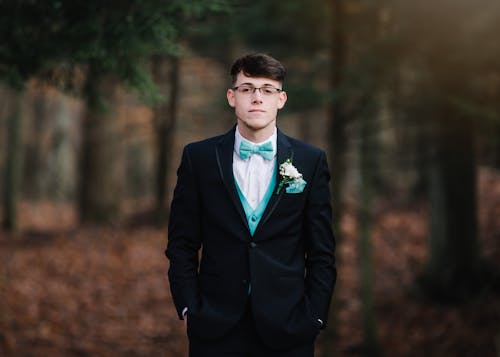 Man Wearing Black Suit Jacket With Teal Bowtie