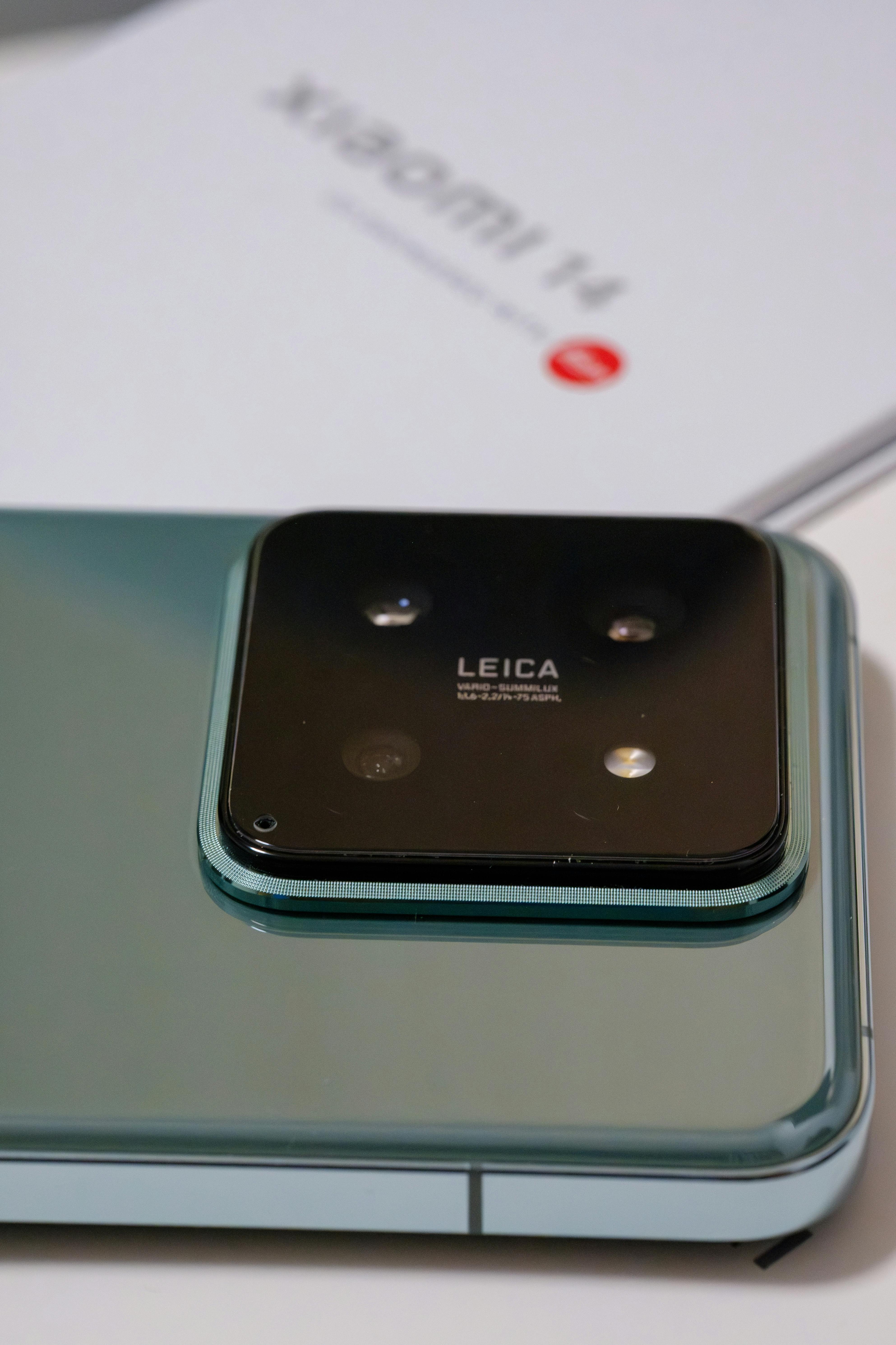 Detailed photo of a smartphone featuring Leica camera lens, highlighting sleek design.