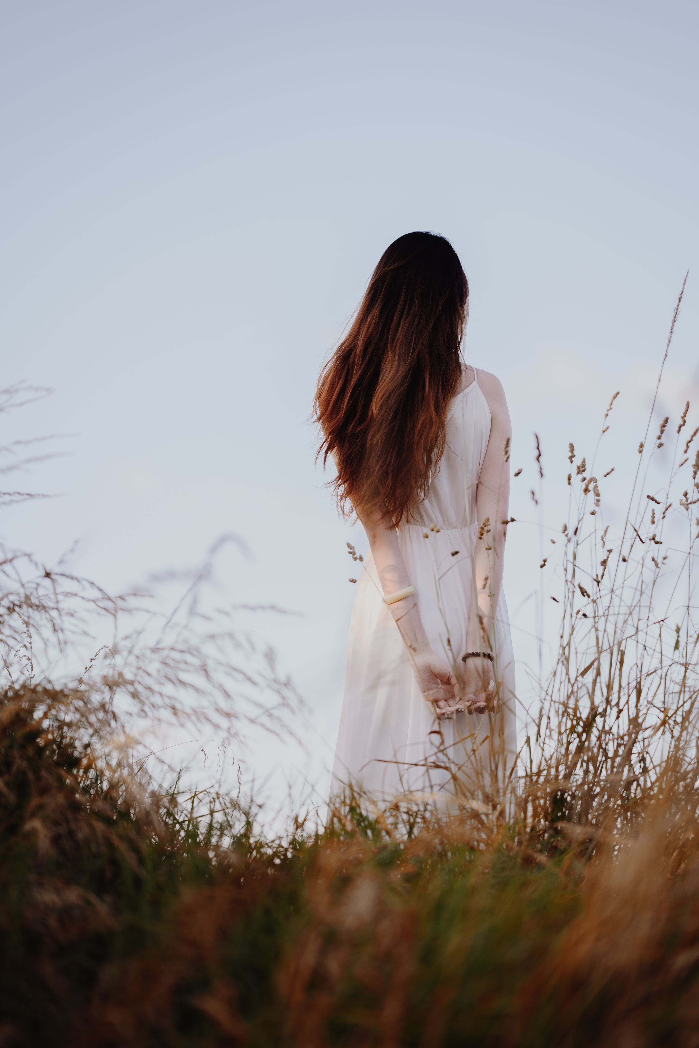 Woman in White Dress Surrounded by Tall Grass  Free Stock Photo
