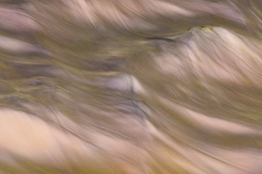 Abstract aerial view of flowing patterns on Guaratuba beach, Paraná, Brazil, showcasing vibrant sand and water textures.