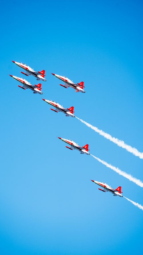 Free High-flying Turkish planes in a synchronized aerial performance against a clear blue sky. Stock Photo