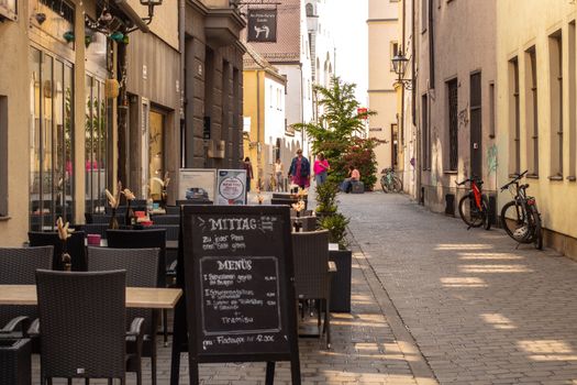 Discover a quaint street cafe in Augsburg's historic center, ideal for a peaceful lunch break.