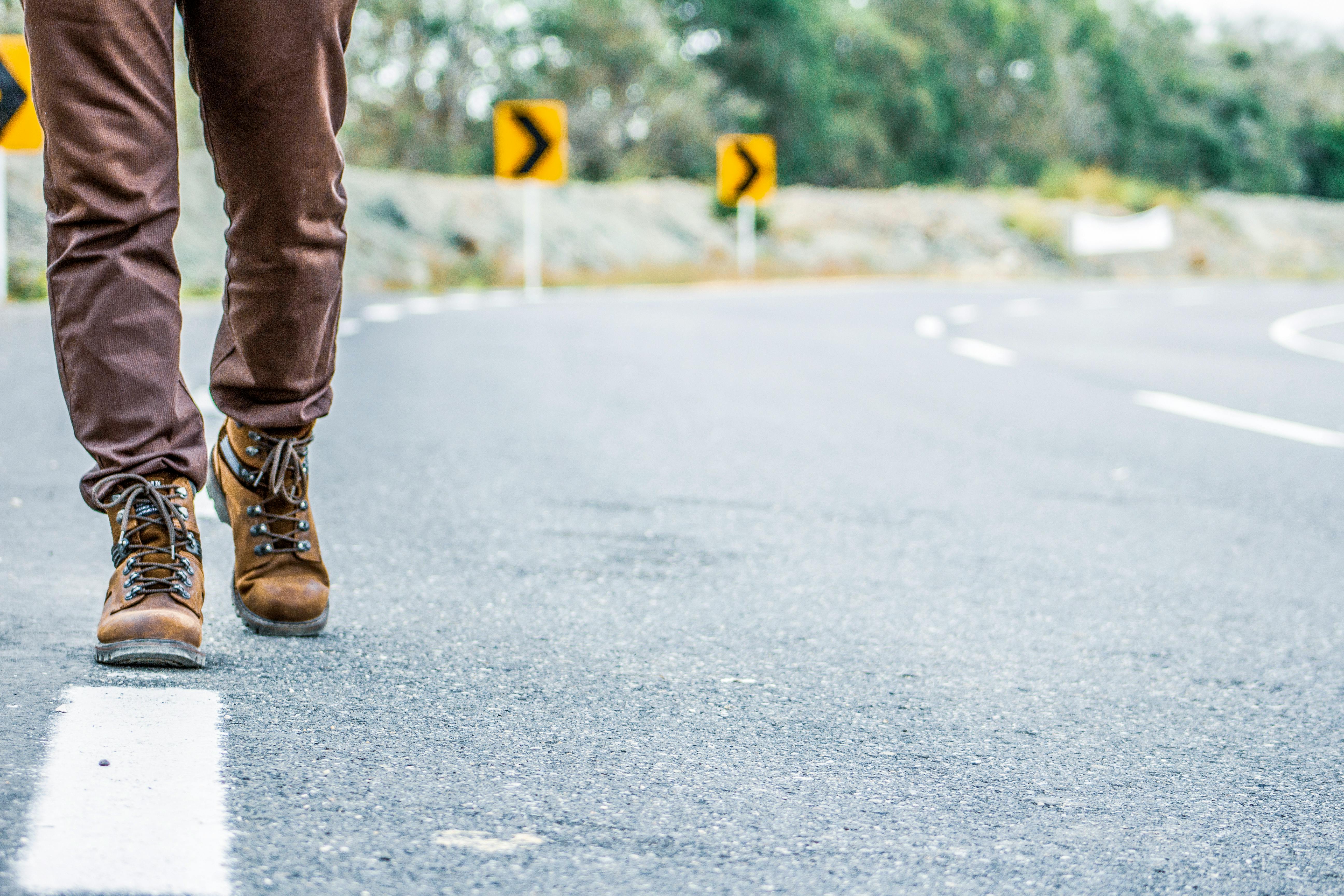 Photo of Person Walking on Road · Free Stock Photo
