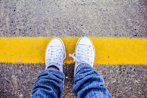 Free Person Wearing White Sneakers Stock Photo