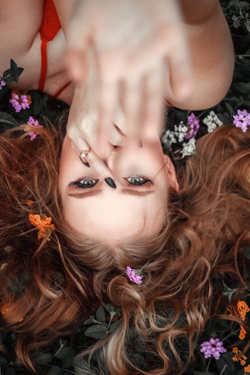 Woman Lying Down on Flowers and Leaves