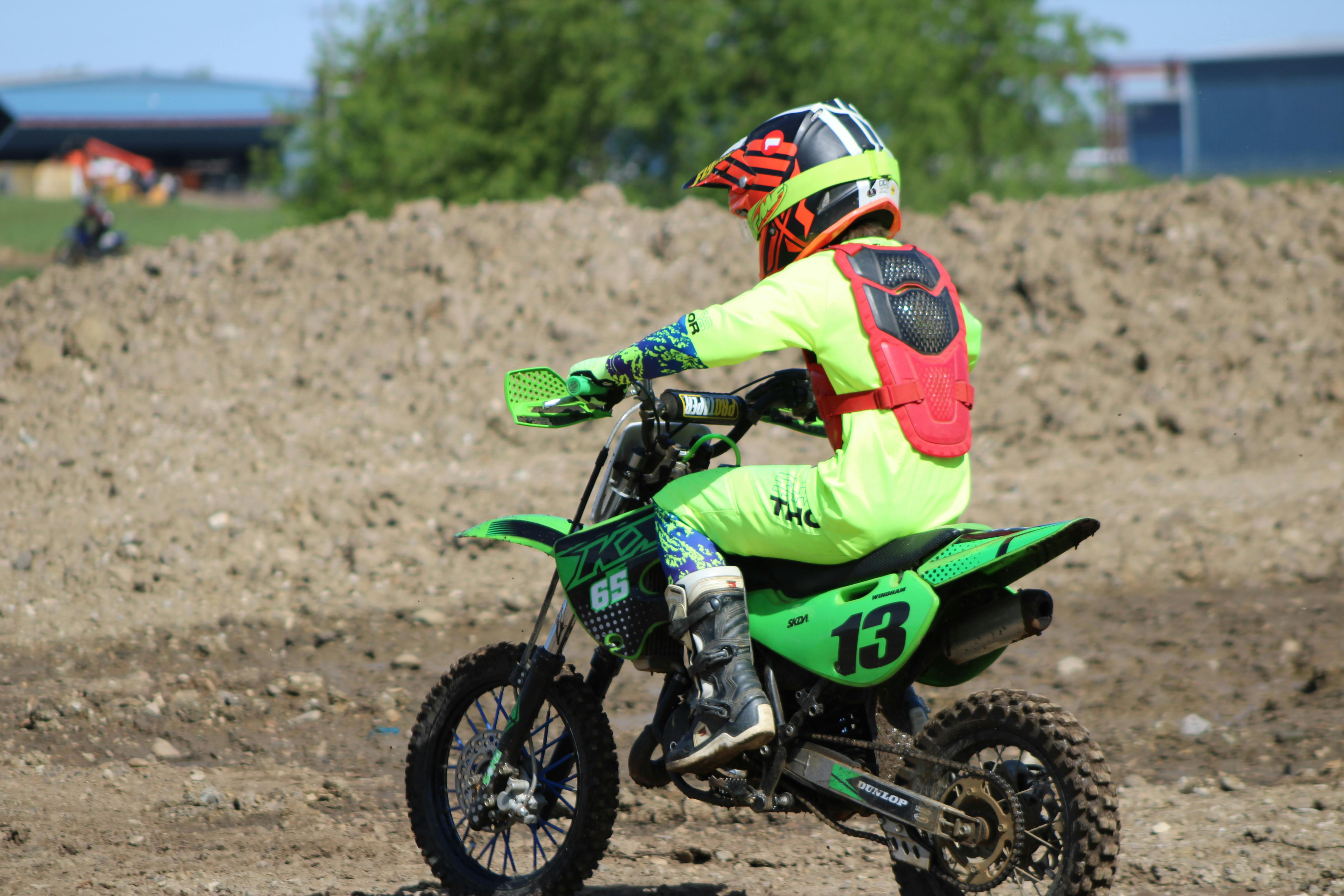 young rider on kawasaki motocross bike outdoors