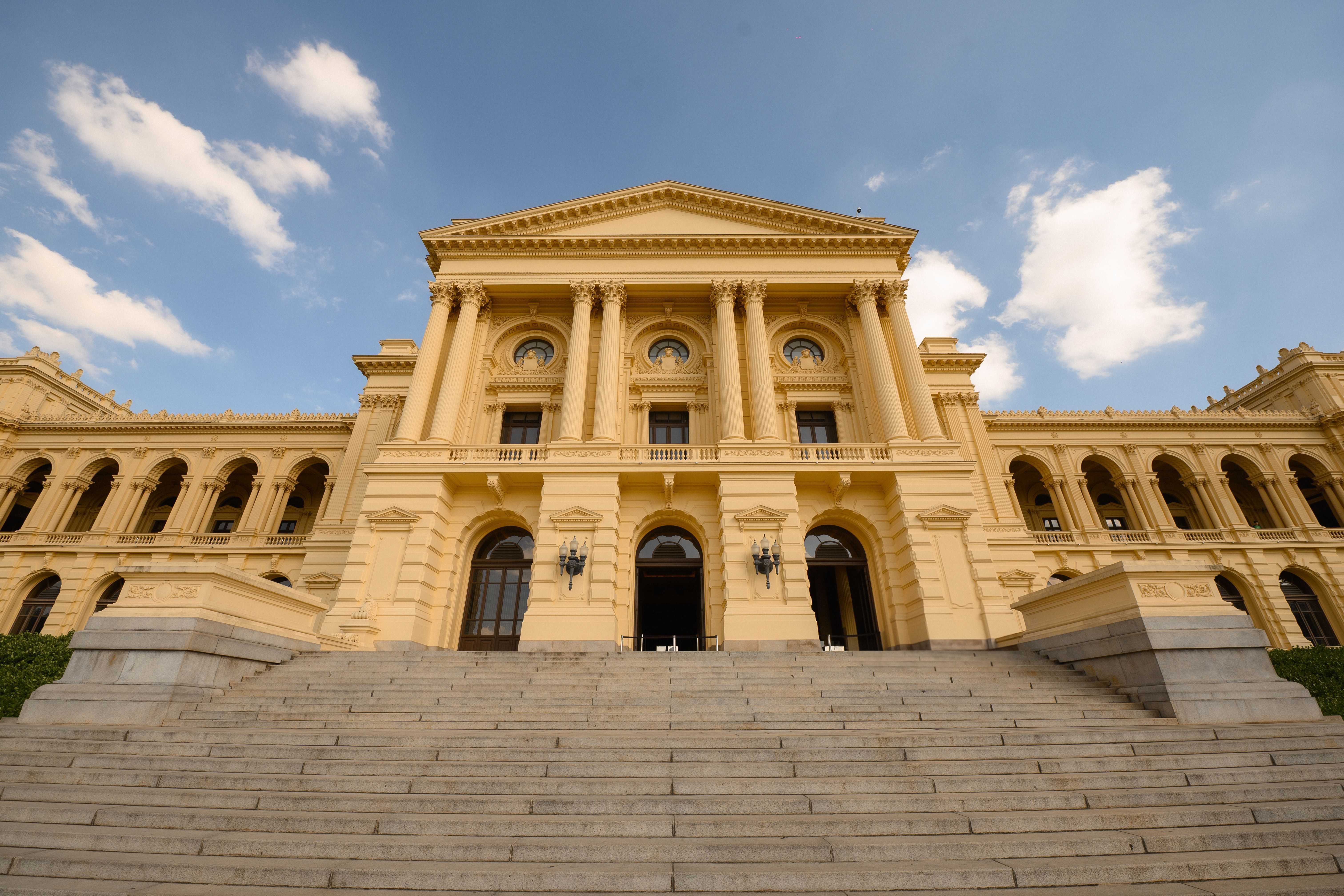 Majestic Neoclassical Building Under Blue Sky · Free Stock Photo