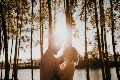 Free Couple Facing Each Other Under Trees Stock Photo