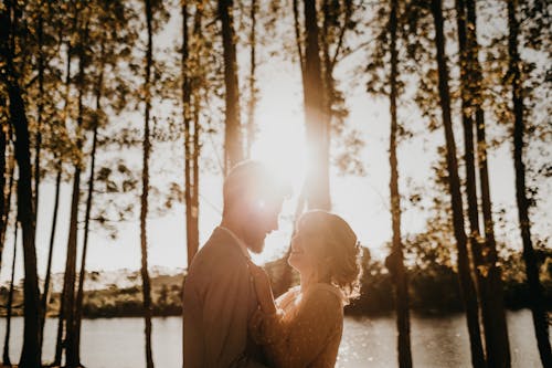 Couple Facing Each Other Under Trees