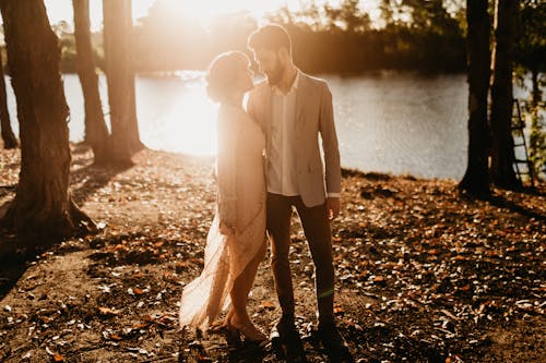 Free Man and Woman Standing Near Lake Stock Photo