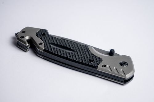 Free High-quality image of a folding knife with a sleek metallic finish on a white background. Stock Photo