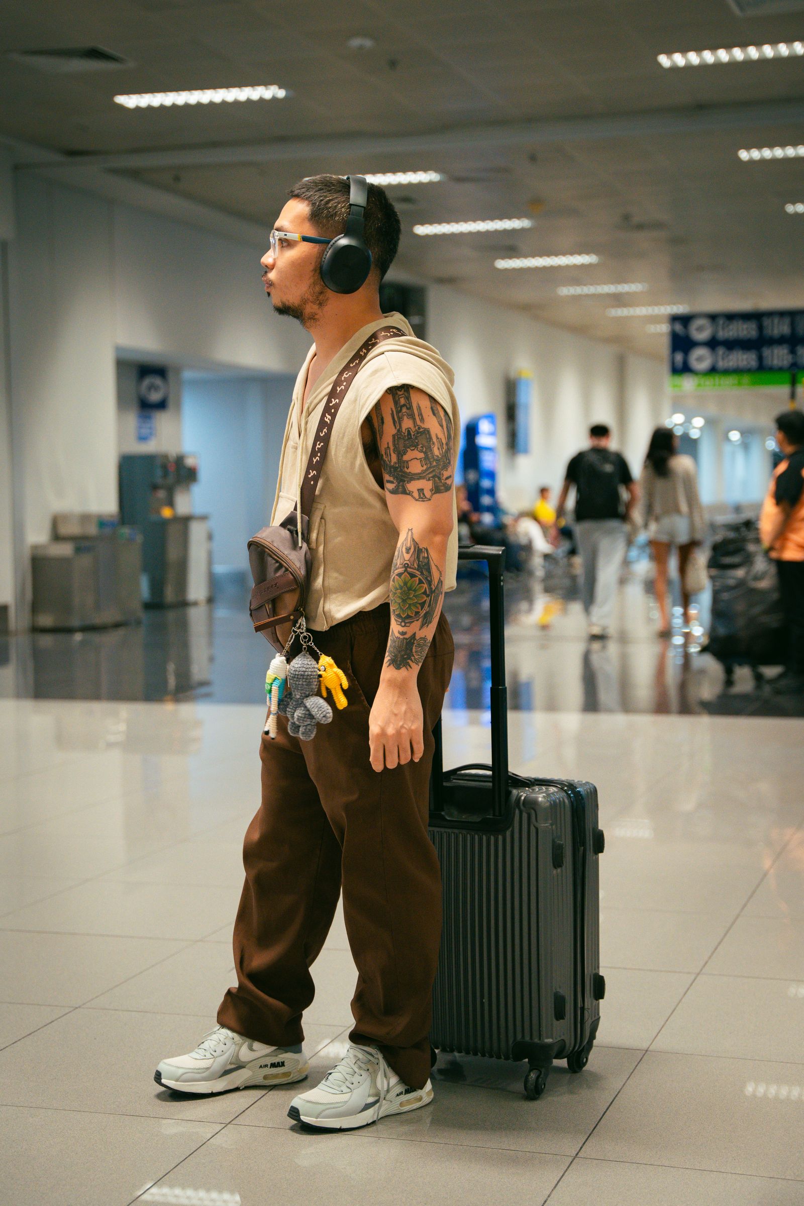 Passenger moving a luggage cart through an airport terminal