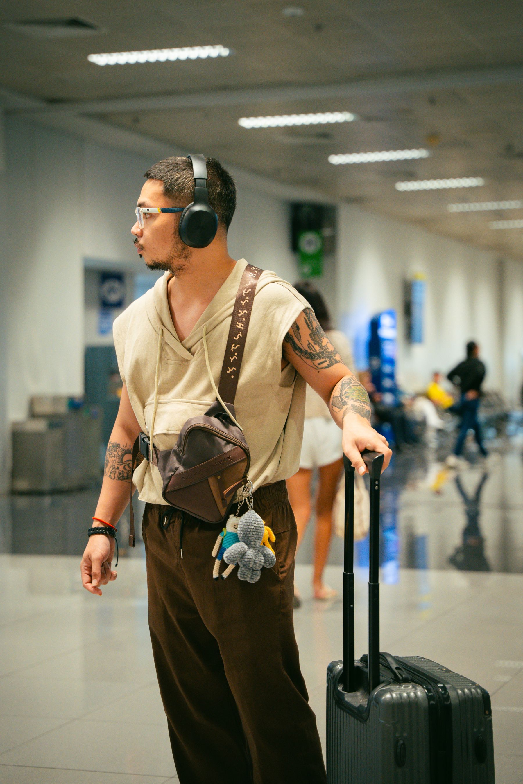 Traveler waiting in an airport terminal with luggage