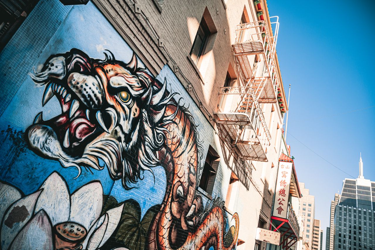 dynamic dragon mural on a city building under clear skies showcasing v